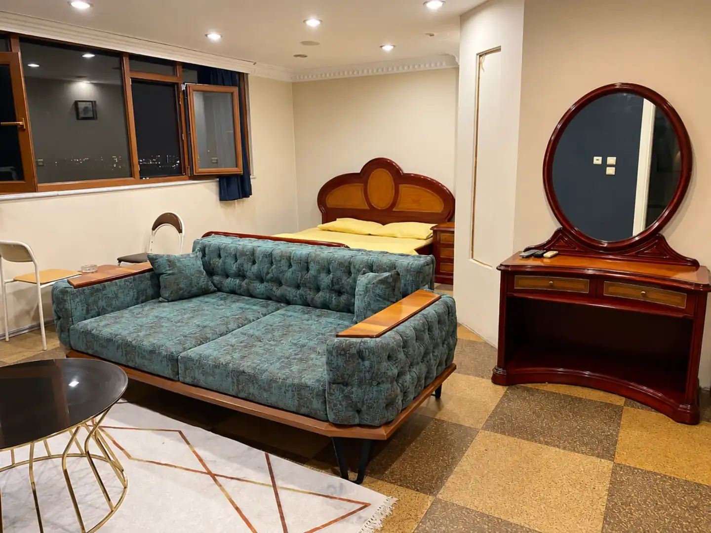 Bed and seating area at Petek Hotel